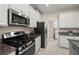 Well-equipped kitchen featuring stainless steel appliances, granite countertops, and ample cabinet space at 3972 Wisdom Trl, Land O Lakes, FL 34638