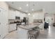 Bright kitchen with white cabinets, granite countertops, stainless steel appliances, and a center island with bar stools at 3972 Wisdom Trl, Land O Lakes, FL 34638