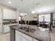Bright kitchen featuring granite countertops, stainless steel appliances, and an open view to the living area at 3972 Wisdom Trl, Land O Lakes, FL 34638