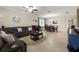Open-concept living room with comfortable seating, tile flooring, and a view into the adjacent dining area at 3972 Wisdom Trl, Land O Lakes, FL 34638