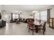 Spacious living room with tile flooring, neutral walls, and large windows for natural light with dining area at 3972 Wisdom Trl, Land O Lakes, FL 34638