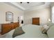 A view of the spacious primary bedroom suite showcasing a tray ceiling and wood furnishings at 3972 Wisdom Trl, Land O Lakes, FL 34638