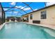 Enjoy the screened-in pool area, complete with lounge chairs and ample seating for outdoor relaxation at 3972 Wisdom Trl, Land O Lakes, FL 34638