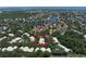 An aerial view of clustered homes with mature trees and community amenities, including water features at 423 Fan Palm Ne Ct, St Petersburg, FL 33703