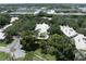 An aerial view of homes with pristine roofs, mature landscaping, and a community pool at 423 Fan Palm Ne Ct, St Petersburg, FL 33703