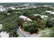 Aerial view of a home nestled among trees and other buildings in a neighborhood at 423 Fan Palm Ne Ct, St Petersburg, FL 33703