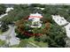Aerial view showcasing the home's setting among mature trees in a well-kept neighborhood at 423 Fan Palm Ne Ct, St Petersburg, FL 33703