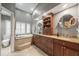 Bathroom features a soaking tub, dual sink vanity, and granite countertops at 423 Fan Palm Ne Ct, St Petersburg, FL 33703