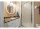 Bathroom features a vanity with granite countertop and a shower with glass door at 423 Fan Palm Ne Ct, St Petersburg, FL 33703