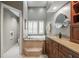 Bathroom features a soaking tub, dual sink vanity, and granite countertops at 423 Fan Palm Ne Ct, St Petersburg, FL 33703