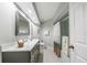 Well-lit bathroom featuring a dual sink vanity with a framed mirror, and a shower with sliding glass doors at 423 Fan Palm Ne Ct, St Petersburg, FL 33703