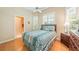 Cozy bedroom with a ceiling fan, shutters on the windows, and an ensuite bathroom at 423 Fan Palm Ne Ct, St Petersburg, FL 33703
