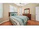 Comfortable bedroom featuring hardwood floors, window shutters, and a decorative ceiling fan at 423 Fan Palm Ne Ct, St Petersburg, FL 33703