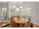 Bright dining area with wood table, chandelier, and plantation shutters at 423 Fan Palm Ne Ct, St Petersburg, FL 33703