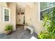 Inviting entryway with tiled floor, neutral bench, and charming front door at 423 Fan Palm Ne Ct, St Petersburg, FL 33703