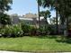 Landscaped home exterior with manicured lawn and trimmed bushes in garden beds at 423 Fan Palm Ne Ct, St Petersburg, FL 33703