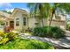 Charming single-Gathering home with mature landscaping, stone walkway, and attached two-car garage at 423 Fan Palm Ne Ct, St Petersburg, FL 33703