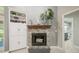 Cozy fireplace with decorative mantle, flanked by built-in shelves, complemented by nearby doorway at 423 Fan Palm Ne Ct, St Petersburg, FL 33703