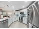 Well-lit kitchen boasting stainless steel appliances, white cabinetry, and sleek countertops with an open layout at 423 Fan Palm Ne Ct, St Petersburg, FL 33703