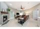 Inviting living room featuring a fireplace, comfortable seating, and a ceiling fan, seamlessly connected to adjacent spaces at 423 Fan Palm Ne Ct, St Petersburg, FL 33703