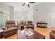 Comfortable living room with wood floors, ceiling fan, and plantation shutters at 423 Fan Palm Ne Ct, St Petersburg, FL 33703