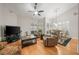 Comfortable living room with wood floors, ceiling fan, and plantation shutters at 423 Fan Palm Ne Ct, St Petersburg, FL 33703