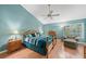 Inviting primary bedroom featuring a ceiling fan, wood floors, and comfortable furnishings at 423 Fan Palm Ne Ct, St Petersburg, FL 33703