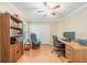 The home office features hardwood floors, a ceiling fan and a built-in bookcase at 423 Fan Palm Ne Ct, St Petersburg, FL 33703
