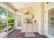 Covered outdoor kitchen featuring a sink, countertop, and cabinets on a brick-paved patio at 423 Fan Palm Ne Ct, St Petersburg, FL 33703