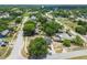 An aerial view of the home in a peaceful, tree-lined neighborhood with convenient access to nearby amenities at 4608 Deltona Blvd, Spring Hill, FL 34606