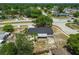 The aerial view shows the home with its mature trees and a screened patio, set along a residential street at 4608 Deltona Blvd, Spring Hill, FL 34606
