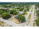 An aerial view shows the home's location in a quiet neighborhood surrounded by mature trees and well-maintained streets at 4608 Deltona Blvd, Spring Hill, FL 34606