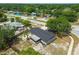 Aerial view of home with screened patio, mature trees and convenient neighborhood street access at 4608 Deltona Blvd, Spring Hill, FL 34606