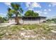 Expansive backyard featuring a screened-in porch with lush greenery at 4608 Deltona Blvd, Spring Hill, FL 34606