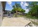 Spacious backyard with a screened-in porch, mature palm tree, and ample space at 4608 Deltona Blvd, Spring Hill, FL 34606