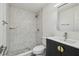 Modern bathroom featuring a tiled walk-in shower and sleek vanity with gold hardware at 4608 Deltona Blvd, Spring Hill, FL 34606