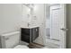 Bathroom featuring a floating vanity with open shelves, stylish fixtures, and modern finishes at 4608 Deltona Blvd, Spring Hill, FL 34606