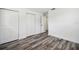 Bright bedroom featuring modern wood floors and ample closet space at 4608 Deltona Blvd, Spring Hill, FL 34606