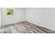 Bright bedroom with wood-look floors and a window that provides natural light at 4608 Deltona Blvd, Spring Hill, FL 34606
