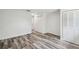 Spacious bedroom with wood-look floors and ample closet space at 4608 Deltona Blvd, Spring Hill, FL 34606