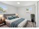 Bright bedroom with stylish furnishings, and two windows for natural light at 4608 Deltona Blvd, Spring Hill, FL 34606