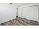 Clean bedroom featuring modern wood floors and ample closet space at 4608 Deltona Blvd, Spring Hill, FL 34606