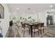 Open concept dining area with modern decor, seamlessly connecting to the living room and kitchen, perfect for entertaining at 4608 Deltona Blvd, Spring Hill, FL 34606