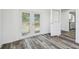 Entryway featuring decorative glass doors and gray wood-look flooring at 4608 Deltona Blvd, Spring Hill, FL 34606
