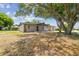 Single-Gathering home showcasing stone accents, a spacious yard, and mature trees, enhancing the property's natural beauty at 4608 Deltona Blvd, Spring Hill, FL 34606