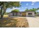 Lovely single-Gathering home showcasing stone accents and a well-manicured lawn, adding to its inviting aesthetic appeal at 4608 Deltona Blvd, Spring Hill, FL 34606
