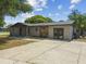 Charming home with neutral siding, stone accents, new landscaping, and a paved driveway at 4608 Deltona Blvd, Spring Hill, FL 34606