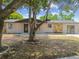Charming home featuring stone accents, neutral siding, and a well-manicured front yard at 4608 Deltona Blvd, Spring Hill, FL 34606
