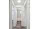 Hallway view into the bathroom showcasing marble-tiled shower and neutral interior paint at 4608 Deltona Blvd, Spring Hill, FL 34606