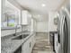 Bright kitchen with stainless steel appliances, granite counters and stainless faucet at 4608 Deltona Blvd, Spring Hill, FL 34606